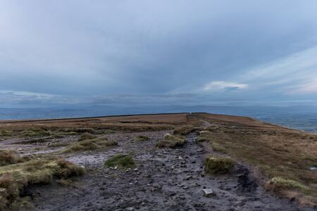 Path with landscape leading on hill, clouds and colored sky