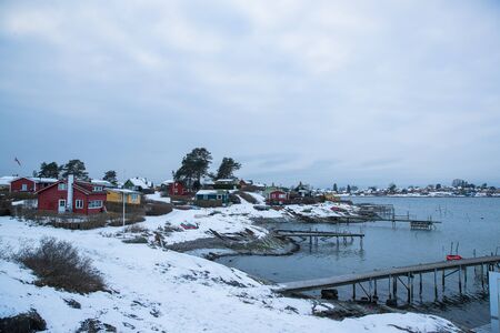 Traditional cottages on the islands around Oslo Norway during the winter overlooking the sea and the Fjord in snow conditionの写真素材