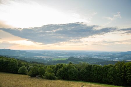 Landscape view on meadow with blue sky with many clouds and forest close to city Valasske Mezirici captured during summer late time.の写真素材