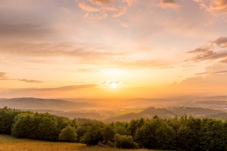 Landscape view on meadow with blue sky with many clouds and forest close to city Valasske Mezirici captured during summer late time.の写真素材