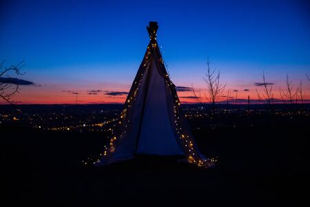 Teepee during dark sunset in quarry Hady Brno with view on city centre.