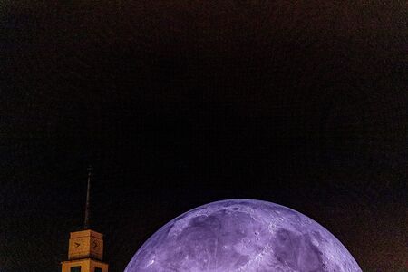 Event City Observatory Brno Kravi Horafull moon  of people shadows moving with Lunalon artificial moon during the evening with the transition into the night when the moon and the city light up.の写真素材
