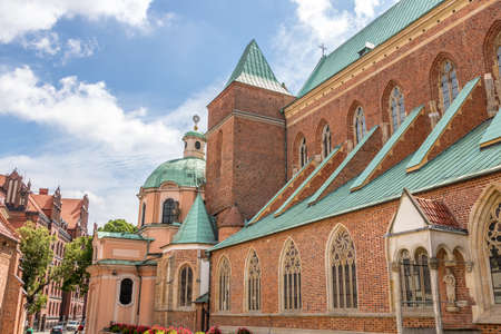 WrocÅaw church with nice sky and clouds from side streetのeditorial素材