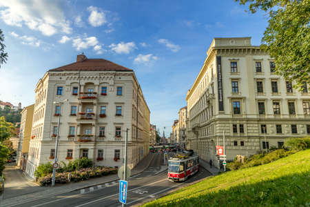 Busy street with people, cars and public transport rush street in Brno Silingrovo namesti square in Czech Republic Europe capture in close shot between buildings.のeditorial素材