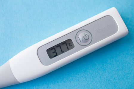 detail of digital thermometer with 37,7 ? C of fever, flu, covid19, virus,の写真素材