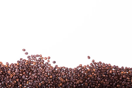 top view of White cup filled with freshly roasted coffee beans isolated on white backgroundの写真素材