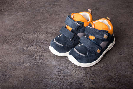 baby shoes, small shoes on concrete background, shoes for a toddlerの写真素材