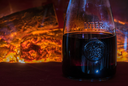 Wine with open fire in backgroundの写真素材