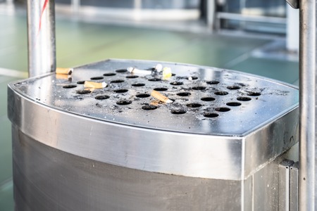 Stainless ashtray with cigarettesの写真素材