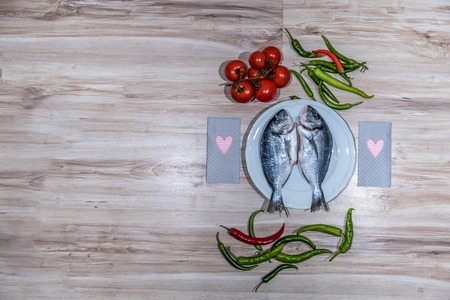 Two grilled seabreams on a plateの写真素材