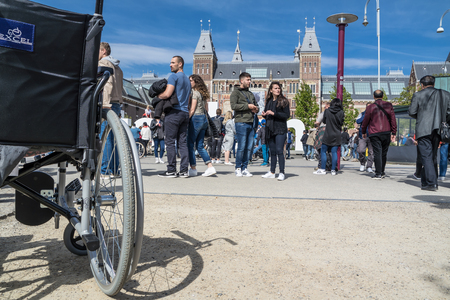 Amsterdam / Netherlands - April 31, 2017 - Wheelchair standing in the middle of the crowd on museumplein in Amsterdamのeditorial素材