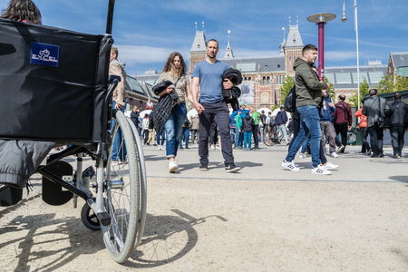 Amsterdam / Netherlands - April 31, 2017 - Wheelchair standing in the middle of the crowd on museumplein in Amsterdamのeditorial素材
