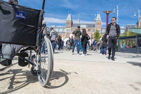 Amsterdam / Netherlands - April 31, 2017 - Wheelchair standing in the middle of the crowd on museumplein in Amsterdamのeditorial素材