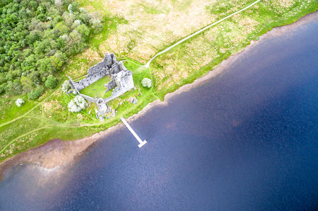 The ruins of historic Kilchurn Castle and jetty on Loch Aweの写真素材