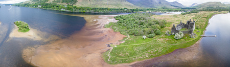 The ruins of historic Kilchurn Castle and jetty on Loch Aweの写真素材