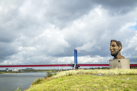 Duisburg / Germany - October 03 2017 : The sculpture Echo of the Poseidon created by Markus Lueppertz is greeting mariners on the mercator islandのeditorial素材