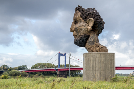 Duisburg / Germany - October 03 2017 : The sculpture Echo of the Poseidon created by Markus Lueppertz is greeting mariners on the mercator islandのeditorial素材