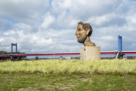 Duisburg / Germany - October 03 2017 : The sculpture Echo of the Poseidon created by Markus Lueppertz is greeting mariners on the mercator islandのeditorial素材
