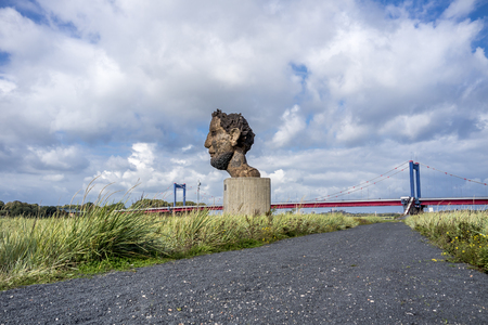 Duisburg / Germany - October 03 2017 : The sculpture Echo of the Poseidon created by Markus Lueppertz is greeting mariners on the mercator islandのeditorial素材