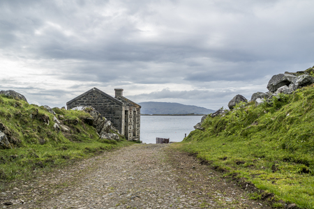 The rotten pier at craignish point with the Sound of Jura in the backgroundの写真素材