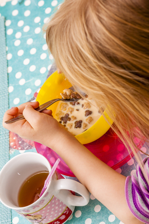 Little girl enjoying the breakfast muesliの写真素材