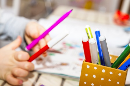 Closeup girl drawing with colorful pencilsの写真素材