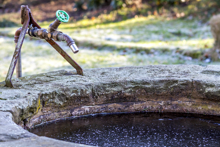 Frozen water and well in the winterの写真素材