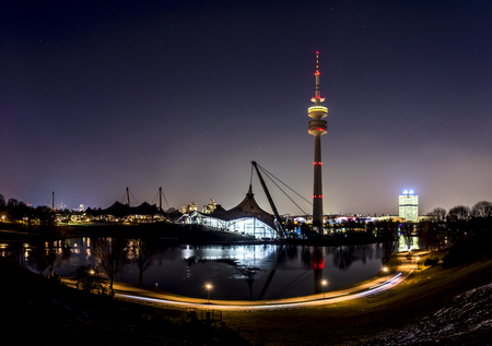 The skyline of Munich in Bavaria, Germany, with reflections in the lake and stars in the skyの写真素材