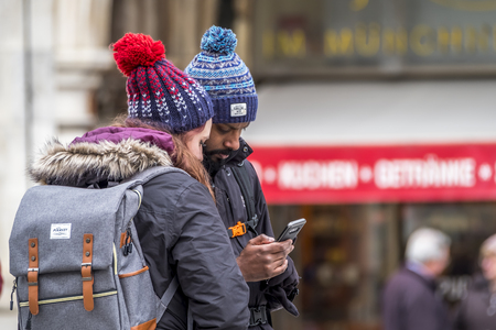 Munich / Germany - February 15 2018: Couple using smartphone to get ravel informationのeditorial素材