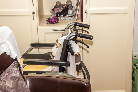 Wheelchair close to chair in a retirement homeの写真素材