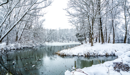 Part frozen pond and path around it in the winterの写真素材