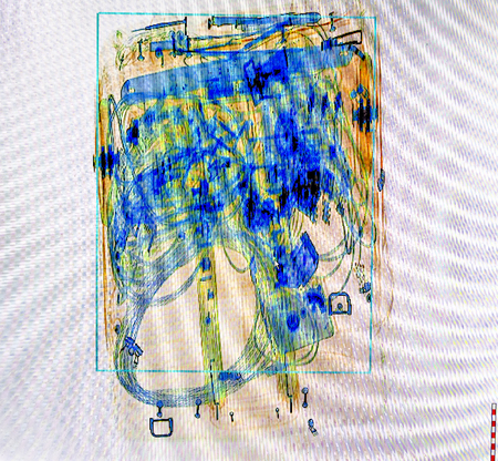 X-ray screenshot of an trolley bag full of cable and electronics.