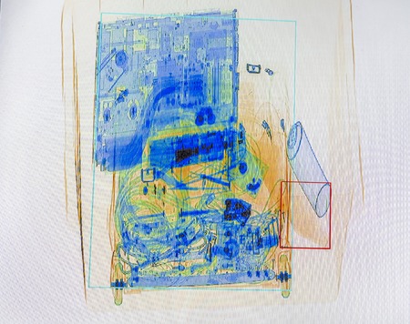 X-ray screenshot of a box with a spray bottle, a bottle of water, a laptop and a camera bag.の写真素材