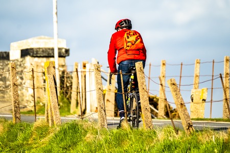 Rear view of a cyclist riding on the streets in Walesの写真素材