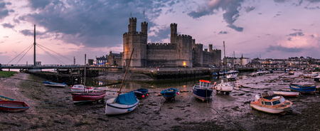 The skyline of Caernafon in Wales during low tide at night - United Kingdomの写真素材
