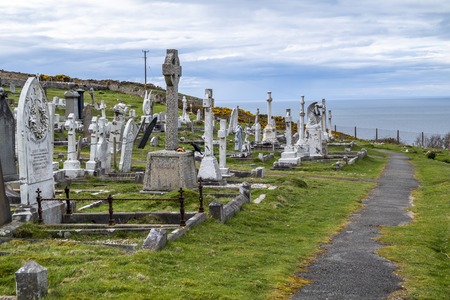 Llandudno / Wales, UK - April 22 2018 : Dramtic graves standing at St Tudnos church and cemetery on the Great Orme at Llandudno, Wales, UKのeditorial素材