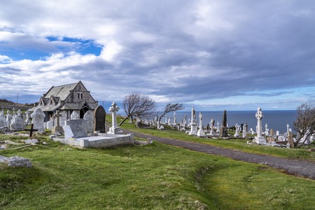 Llandudno / Wales, UK - April 22 2018 : Dramtic graves standing at St Tudnos church and cemetery on...