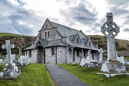 Llandudno / Wales, UK - April 22 2018 : Dramatic graves standing at St Tudnos church and cemetery on the Great Orme at Llandudno, Wales, UKのeditorial素材