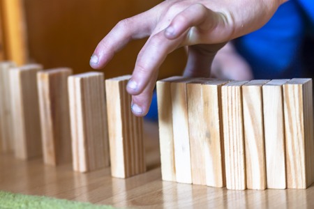 Boy playing with wooden blocks - ready to tilt