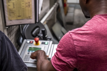 African man showing how to use the automated warehosue-の写真素材