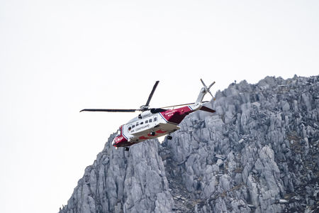 Ogwen Glen / Wales - April 29 2018 : British HM Coastguard helicopter Sikorsky S-92 operated by Bristow Helicopters conducting a rescue exercise at Ogwen Glenのeditorial素材