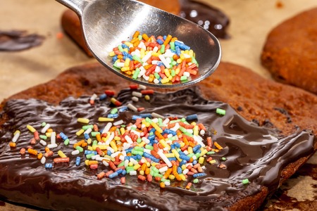 Preparing cookies with hot brown delicious molten chocolate and coarse sugarの写真素材