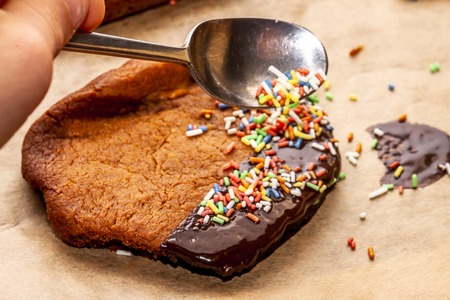 Preparing cookies with hot brown delicious molten chocolate and coarse sugar