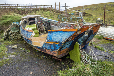 Rotten old boat wreck in scottish harbourの写真素材