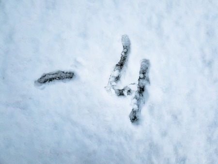 Temperature of -4 written in the freshly fallen snowの写真素材