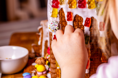 Familiy building a sweet ginger bread houseの写真素材