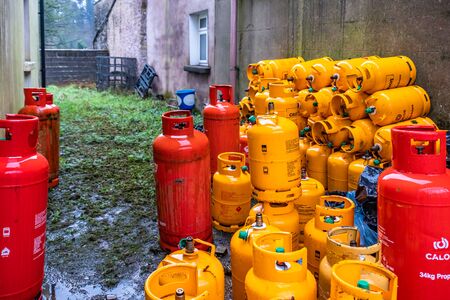 Pettigo / Ireland - March 03 2019 : Rows of LPG Gas bottles stored behind the houseのeditorial素材