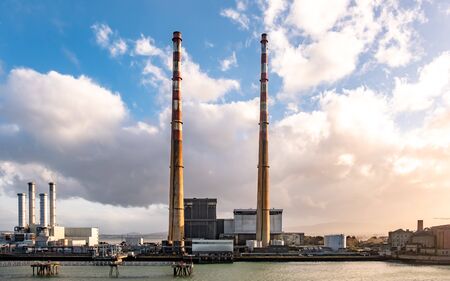 Dublin / Ireland - March 03 2019: Poolbeg power station in the harbour producing during sunset