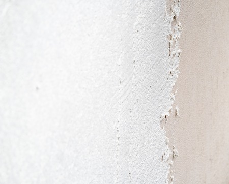 Construction worker plastering and smoothing concrete wall with cementの写真素材