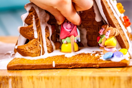 Familiy building a sweet ginger bread house